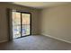 This spacious bedroom features a sliding glass door to a balcony and neutral carpeting at 731 Hanover Se Ln, Marietta, GA 30067