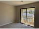 The bedroom has carpeted floors, neutral-colored walls, and a sliding glass door at 731 Hanover Se Ln, Marietta, GA 30067