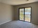 This bedroom features carpeted floors and a sliding glass door with balcony access at 731 Hanover Se Ln, Marietta, GA 30067