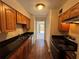 Galley kitchen boasting black countertops, stainless steel appliances, and ample cabinet space at 731 Hanover Se Ln, Marietta, GA 30067