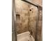 The tiled shower features built-in niche and sliding glass doors for ease of access at 731 Hanover Se Ln, Marietta, GA 30067