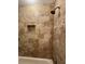 A well-appointed shower with designer tiles, a niche, and a modern shower head at 731 Hanover Se Ln, Marietta, GA 30067