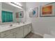 Bright bathroom with a double vanity, large mirror, and modern decor at 1025 Grace Dr, Lawrenceville, GA 30043