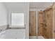 Bathroom featuring a bathtub, shower, and frosted glass window at 1765 Stone Meadow Rd, Lithonia, GA 30058