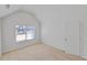 Bedroom featuring neutral carpet, large window and a vaulted ceiling at 1765 Stone Meadow Rd, Lithonia, GA 30058