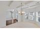 Elegant dining room with coffered ceilings, chandelier and view of the front yard at 1765 Stone Meadow Rd, Lithonia, GA 30058