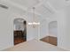 Bright dining room with elegant chandelier, tray ceiling, and arched entryway at 1765 Stone Meadow Rd, Lithonia, GA 30058