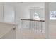 Upstairs hallway featuring a decorative railing and chandelier at 1765 Stone Meadow Rd, Lithonia, GA 30058