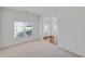 Bright living room featuring a large window with blinds and an arched doorway at 1765 Stone Meadow Rd, Lithonia, GA 30058