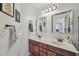 This bathroom features double sinks, warm wood cabinets, and framed mirrors at 2755 Turning Leaf Dr, Lawrenceville, GA 30044