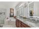 Modern bathroom with double sink vanity, granite counters, soaking tub, and glass-enclosed shower at 2755 Turning Leaf Dr, Lawrenceville, GA 30044