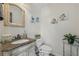 Charming powder room with decorative mirror, marble countertop sink, and blue floral wall art at 2755 Turning Leaf Dr, Lawrenceville, GA 30044