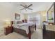 Cozy bedroom featuring a ceiling fan, a wood bed frame, and natural light from the window at 2755 Turning Leaf Dr, Lawrenceville, GA 30044