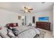 This bedroom features a ceiling fan, soft carpet, and a comfy chair at 2755 Turning Leaf Dr, Lawrenceville, GA 30044