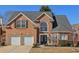 Charming two-story brick home with a well-manicured lawn and attached two-car garage at 2755 Turning Leaf Dr, Lawrenceville, GA 30044