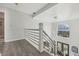 Hallway with modern railing offers views of transom windows over exterior doors at 2755 Turning Leaf Dr, Lawrenceville, GA 30044