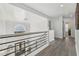 Hallway boasts modern railing and transom windows above the exterior doors at 2755 Turning Leaf Dr, Lawrenceville, GA 30044