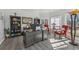 Bright home office featuring large windows, gray desk, bookshelves, and wood plank flooring at 2755 Turning Leaf Dr, Lawrenceville, GA 30044