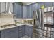 Modern kitchen featuring gray cabinetry, stainless steel appliances, and white subway tile backsplash at 2755 Turning Leaf Dr, Lawrenceville, GA 30044