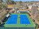 Overhead view of community tennis courts ready for a match, with nearby lake and playground at 2755 Turning Leaf Dr, Lawrenceville, GA 30044