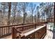 Inviting back deck featuring wooden railings and serene wooded views, perfect for outdoor relaxation at 5930 N Eton Ct, Duluth, GA 30097