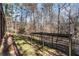 A backyard featuring mature trees and foliage with a metal structure for covering at 5930 N Eton Ct, Duluth, GA 30097