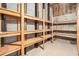 Open Basement storage area featuring unfinished cinderblock walls and sturdy wooden shelving at 5930 N Eton Ct, Duluth, GA 30097