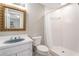 Vintage bathroom featuring a tiled shower, a sink, a toilet, and mirrored wall at 5930 N Eton Ct, Duluth, GA 30097