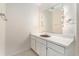 Bathroom featuring a long vanity, a sink, a mirror with lights, and neutral walls at 5930 N Eton Ct, Duluth, GA 30097