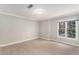 Bright bedroom featuring wood floors, a modern window, and light-colored walls at 5930 N Eton Ct, Duluth, GA 30097