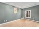 View of a neutral bedroom featuring wood floors, a modern window, and pale green walls at 5930 N Eton Ct, Duluth, GA 30097