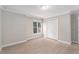 Bedroom with wood floors, a modern window, a closet, and light-colored walls at 5930 N Eton Ct, Duluth, GA 30097