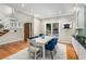 Bright dining room featuring a modern table with blue chairs, wood floors, and access to the outdoor patio at 5930 N Eton Ct, Duluth, GA 30097