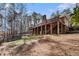 A backyard elevation of a brick home featuring a large wooden back porch at 5930 N Eton Ct, Duluth, GA 30097