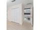 Hallway featuring wood floors, a double closet, and a modern open-doorway window at 5930 N Eton Ct, Duluth, GA 30097