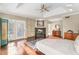 This main bedroom features a ceiling fan, fireplace, and an attached private balcony at 5930 N Eton Ct, Duluth, GA 30097