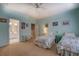 Bedroom featuring two twin beds, light turquoise walls, carpet floors with doorway to bathroom at 9235 Heatherton Walk, Duluth, GA 30097