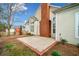 Backyard showing neutral siding, patio area with brick chimney and blue skies at 1545 Heritage Trl, Roswell, GA 30075
