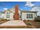 This cozy backyard has a brick patio and a partial view of the home's siding at 1545 Heritage Trl, Roswell, GA 30075