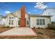 Exterior of home highlighting a brick chimney, patio area, and neutral siding at 1545 Heritage Trl, Roswell, GA 30075