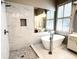 Bright bathroom featuring soaking tub, and shower with white marble surround at 1545 Heritage Trl, Roswell, GA 30075