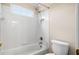 A well-lit, white tiled bathroom with a shower-tub combo at 1545 Heritage Trl, Roswell, GA 30075