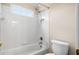 Simple bathroom with a white tile tub and shower combo and a standard toilet at 1545 Heritage Trl, Roswell, GA 30075