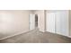 Bedroom featuring carpet, neutral colored walls, a closet and a door leading to the upstairs at 1545 Heritage Trl, Roswell, GA 30075