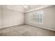 Spacious bedroom with neutral carpeting and a large window at 1545 Heritage Trl, Roswell, GA 30075
