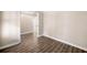 Spacious bedroom showcasing hardwood floors, neutral walls, and a view into the hallway at 1545 Heritage Trl, Roswell, GA 30075