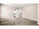 Bedroom with neutral walls, carpet, and doors leading to bathroom and upstairs at 1545 Heritage Trl, Roswell, GA 30075