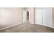 Bedroom showing an open door, and double door closet with neutral walls and carpeted floor at 1545 Heritage Trl, Roswell, GA 30075