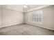 Neutral bedroom with carpet, tray ceiling, and shuttered windows at 1545 Heritage Trl, Roswell, GA 30075