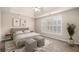 Staged bedroom featuring large windows, neutral tones, and a ceiling fan at 1545 Heritage Trl, Roswell, GA 30075